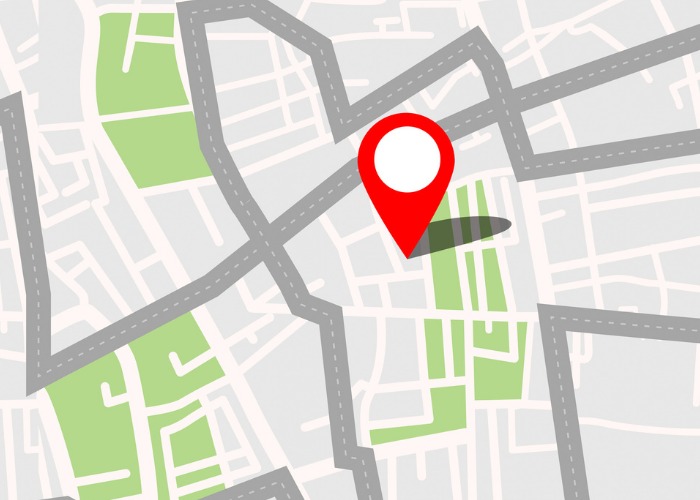 A location is pinned on an animated street map