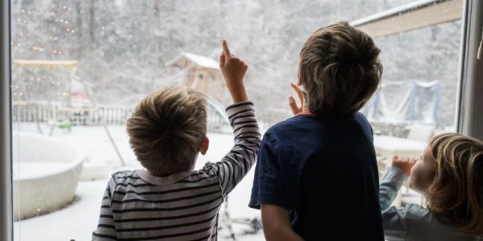 kids looking at snow outside