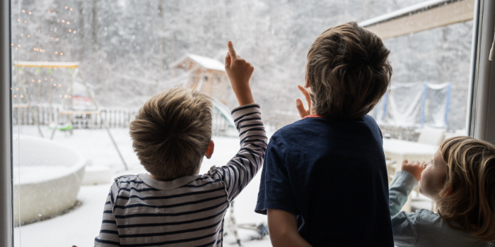 kids looking at snow outside