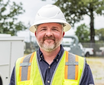 Summit team member standing in front of truck